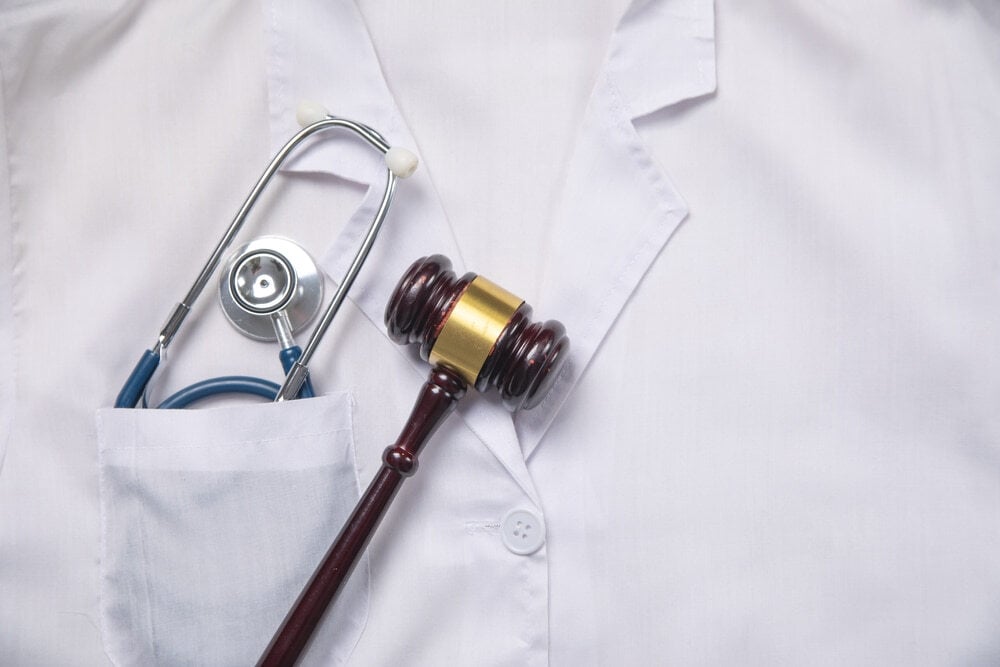 Judge gavel with a stethoscope on doctor clothes